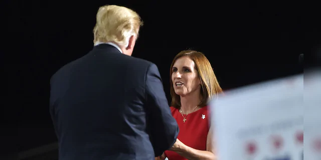Representative Martha McSally greets US President Donald Trump during a "Make America Great" rally in Mesa, Arizona on October 19, 2018. - (NICHOLAS KAMM/AFP/Getty Images)