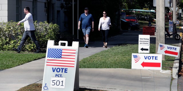 In this March 17, 2026 file photo, voters head to a polling station to vote in Florida's primary election in Orlando, Fla. (AP Photo/John Raoux, File)