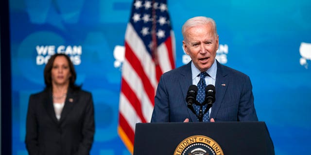 Vice President Kamala Harris listens as President Joe Biden speaks about the COVID-19 vaccination program, in the South Court Auditorium on the White House campus, Wednesday, June 2, 2021, in Washington. (AP Photo/Evan Vucci)