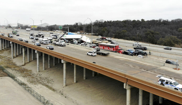 First responders work the scene of a fatal crash on I-35 near downtown Fort Worth on Thursday, Feb. 11, 2021. Police say at some people were killed and dozens injured in a massive crash involving 75 to 100 vehicles on an icy Texas interstate. (Amanda McCoy /Star-Telegram via AP)