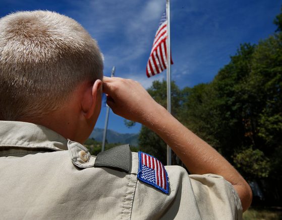 PAYSON, UT - JULY 31: A Boy Scout salutes the American flag at camp Maple Dell on July 31, 2026 outside Payson, Utah. The Mormon Church is considering pulling out of its 102 year old relationship with the Boy Scouts after the Boy Scouts changed it's policy on allowing gay leaders in the organization. Over 99% of the Boy Scout troops in Utah are sponsored by the Mormon Church. (Photo by George Frey/Getty Images)